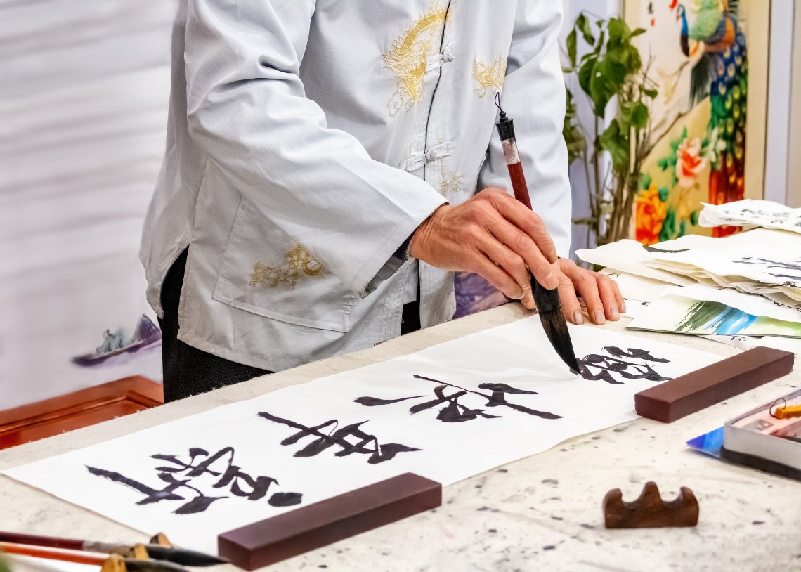 A man writing Chinese calligraphy